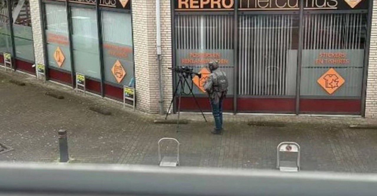 Man holds several people inside Dutch cafe