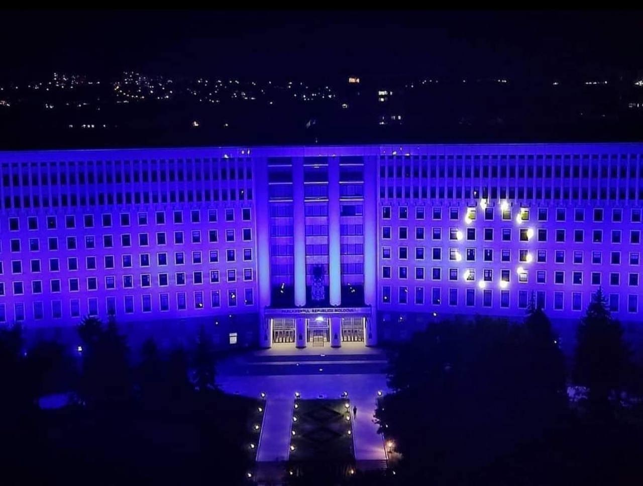 Parliament building in Chisinau, illuminated in the colors of the European flag