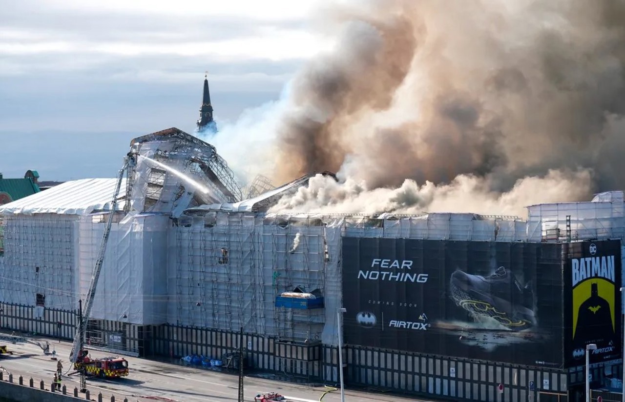 Fire rages through the 17th-century Old Stock Exchange in Copenhagen, toppling the iconic spire